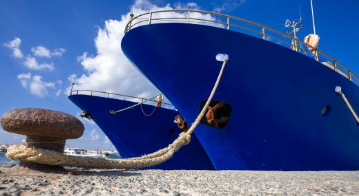 The port side of a cargo ship while docked.