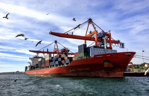 A large cargo vessel, like a container ship, may take on ballast as goods are offloaded from its deck.