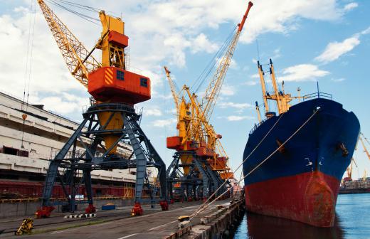 Cargo ships load and unload at seaport freight terminals.