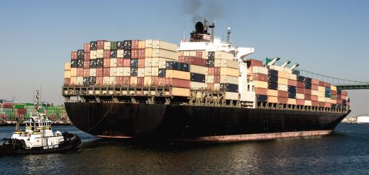 Cargo ships are a common sight at a landing stage.