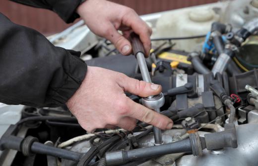 A mechanic servicing a car engine.