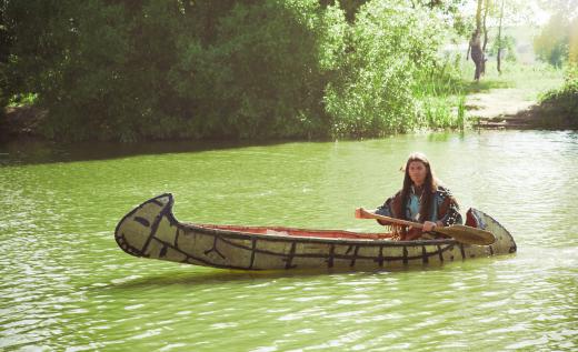 The gunwhale on a canoe noticeably curves toward the waterline at the boat's midsection.